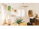 Bright living room with wood floors, white sofa, a hanging plant, and lots of natural light at 3756 E Alamo St, San Tan Valley, AZ 85140