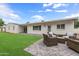 Well-manicured backyard has a patio and seating area, grass, and an exterior view of the home at 4018 E Coolidge St, Phoenix, AZ 85018