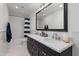 Bathroom with double vanity, white tile, and black cabinets at 4018 E Coolidge St, Phoenix, AZ 85018