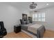 Bright bedroom with light wood floors, white walls, grey bedspread, and drum chandelier at 4018 E Coolidge St, Phoenix, AZ 85018
