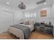 This bedroom includes a ceiling fan, light wood floors, white walls, and a desk at 4018 E Coolidge St, Phoenix, AZ 85018