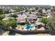 Beautiful aerial view of a home with a sparkling pool, covered patio, and well-maintained yard in a quiet neighborhood at 4126 E Windrose Dr, Phoenix, AZ 85032
