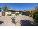 Cozy backyard patio featuring outdoor seating, desert landscaping, and decorative accents at 4126 E Windrose Dr, Phoenix, AZ 85032