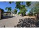 Private backyard featuring a covered patio, lush greenery, and ample space for outdoor enjoyment at 4126 E Windrose Dr, Phoenix, AZ 85032