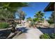 Inviting backyard with lush greenery, a covered patio, and access to a sparkling pool for outdoor enjoyment at 4126 E Windrose Dr, Phoenix, AZ 85032