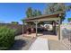 Charming backyard patio featuring a cozy seating area, grill, and hot tub for relaxing outdoor living at 4126 E Windrose Dr, Phoenix, AZ 85032