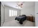 Inviting bedroom with ceiling fan, plantation shutters, and ample storage including a dresser and nightstand at 4126 E Windrose Dr, Phoenix, AZ 85032