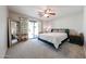 Serene bedroom with carpet, a ceiling fan, and sliding glass doors to the backyard at 4126 E Windrose Dr, Phoenix, AZ 85032