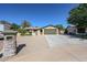 Front exterior of the single-story home featuring desert landscape with a green garage door at 4126 E Windrose Dr, Phoenix, AZ 85032