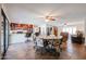 Open-concept kitchen, dining, and living space featuring tile floors, ceiling fans, and neutral colors at 4126 E Windrose Dr, Phoenix, AZ 85032