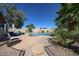 Sparkling swimming pool with rock waterfall, surrounded by tropical landscaping, offering a private retreat at 4126 E Windrose Dr, Phoenix, AZ 85032
