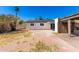View of the backyard from the yard, featuring a covered patio and solar panels at 4147 W Reade Ave, Phoenix, AZ 85019