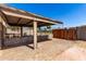 View of a shady covered patio with a wooden gate and cinder block decor at 4147 W Reade Ave, Phoenix, AZ 85019