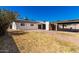 Spacious backyard with solar panels, a covered patio, and brick-paver hardscape at 4147 W Reade Ave, Phoenix, AZ 85019