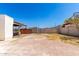 View of a brick paver hardscape in the large backyard with fence and gate at 4147 W Reade Ave, Phoenix, AZ 85019