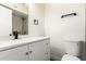 Bathroom featuring a white vanity with quartz countertop, modern faucet, and toilet at 4147 W Reade Ave, Phoenix, AZ 85019