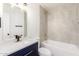 Bright bathroom with modern finishes, blue vanity, and shower over tub with tiled surround at 4147 W Reade Ave, Phoenix, AZ 85019