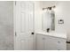 Bathroom features a modern mirror, white vanity, modern faucet and hardware at 4147 W Reade Ave, Phoenix, AZ 85019