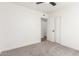 Bright bedroom featuring neutral carpeting, modern ceiling fan, and closet access at 4147 W Reade Ave, Phoenix, AZ 85019