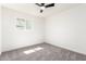 Bedroom featuring neutral carpeting, modern ceiling fan, and large window at 4147 W Reade Ave, Phoenix, AZ 85019