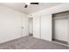Bright bedroom featuring neutral carpeting, modern ceiling fan, and closet at 4147 W Reade Ave, Phoenix, AZ 85019