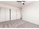 Bedroom featuring neutral carpeting, modern ceiling fan, and closet access at 4147 W Reade Ave, Phoenix, AZ 85019
