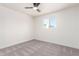 Bedroom featuring neutral carpeting, modern ceiling fan, and large window at 4147 W Reade Ave, Phoenix, AZ 85019