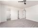 Spacious bedroom featuring neutral carpeting, modern ceiling fan, and closet access at 4147 W Reade Ave, Phoenix, AZ 85019