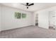 Bedroom with plush carpeting, ceiling fan, ensuite bathroom and ample natural light at 4147 W Reade Ave, Phoenix, AZ 85019