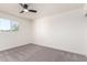 Bright bedroom featuring neutral carpeting, modern ceiling fan, and large window at 4147 W Reade Ave, Phoenix, AZ 85019