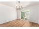 Bright dining room featuring wood floors, modern light fixture, and neutral paint at 4147 W Reade Ave, Phoenix, AZ 85019