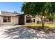 Inviting single-story home with solar panels, a well-manicured lawn, and a welcoming front entrance at 4147 W Reade Ave, Phoenix, AZ 85019