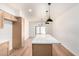 Kitchen with island, wood cabinets and stainless appliances leading to a bright eating area at 4147 W Reade Ave, Phoenix, AZ 85019