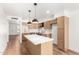 Well-lit kitchen featuring stainless appliances, kitchen island, and wood flooring and cabinets at 4147 W Reade Ave, Phoenix, AZ 85019