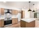 Kitchen featuring stainless steel appliances, an island, and wood cabinets at 4147 W Reade Ave, Phoenix, AZ 85019