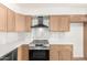 Modern kitchen features stainless appliances, quartz counters, gold hardware and wood cabinets at 4147 W Reade Ave, Phoenix, AZ 85019