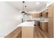 Bright kitchen features a large island, stainless steel appliances, and sleek, modern cabinets at 4147 W Reade Ave, Phoenix, AZ 85019
