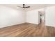 Bright living room featuring wood floors, a ceiling fan and neutral paint at 4147 W Reade Ave, Phoenix, AZ 85019