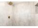 This shower includes new tile, sleek fixtures, and a built-in niche for added storage at 4147 W Reade Ave, Phoenix, AZ 85019