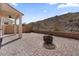 Outdoor patio with a built-in fire pit, desert landscaping and covered seating at 421 W Mountain Sage Dr, Phoenix, AZ 85045