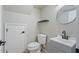 A minimalist bathroom features a toilet, vanity with sink, modern faucet, and wall mirror at 421 W Mountain Sage Dr, Phoenix, AZ 85045