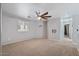 A carpeted primary bedroom boasts a ceiling fan and a wall mount for a TV at 421 W Mountain Sage Dr, Phoenix, AZ 85045