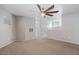 An upstairs bedroom features carpet flooring, a ceiling fan, and a wall mount for a TV at 421 W Mountain Sage Dr, Phoenix, AZ 85045