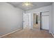Bedroom displays gray walls, brown carpet, and closet with mirror doors at 421 W Mountain Sage Dr, Phoenix, AZ 85045