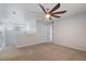 An upstairs bedroom with carpet flooring, a ceiling fan, and access to a shared living space at 421 W Mountain Sage Dr, Phoenix, AZ 85045
