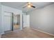 Bedroom features neutral walls, a ceiling fan, and a closet with mirrored doors at 421 W Mountain Sage Dr, Phoenix, AZ 85045