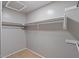 Walk-in closet with built-in shelving and carpeted floor at 421 W Mountain Sage Dr, Phoenix, AZ 85045