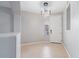 This modern entryway features tile flooring, a statement light fixture, and a neutral color palette at 421 W Mountain Sage Dr, Phoenix, AZ 85045