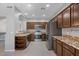 Modern kitchen boasts stainless steel appliances, granite countertops, ample cabinetry, and tile flooring at 421 W Mountain Sage Dr, Phoenix, AZ 85045