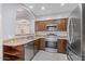 This kitchen features granite countertops, stainless steel appliances, and dark wood cabinets at 421 W Mountain Sage Dr, Phoenix, AZ 85045